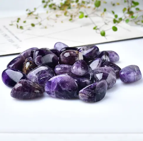 Amethyst tumbled stones in dark purple with swirls of lighter purple and lilac veins.