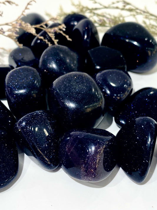 Blue goldstone crystal tumbled stones in deep navy with starlight flecks.