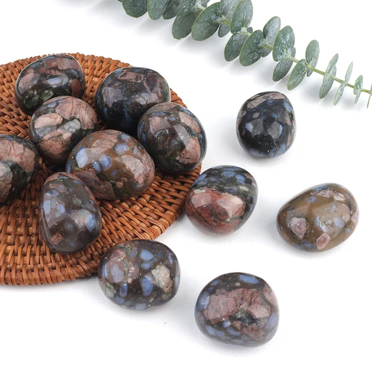Llanite tumbled stones in dark and warm brown with earthy red patches and flecks of pastel blue.