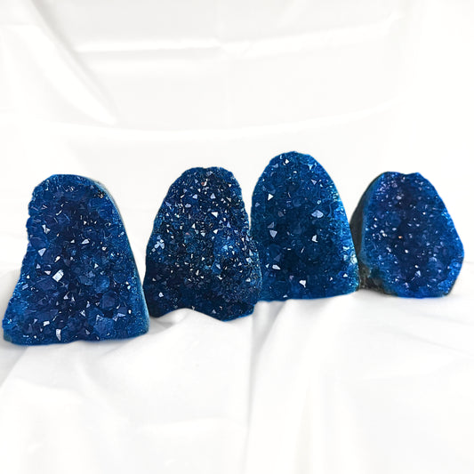 Four Blue Amethyst Crystal stones in deep blue shades.
