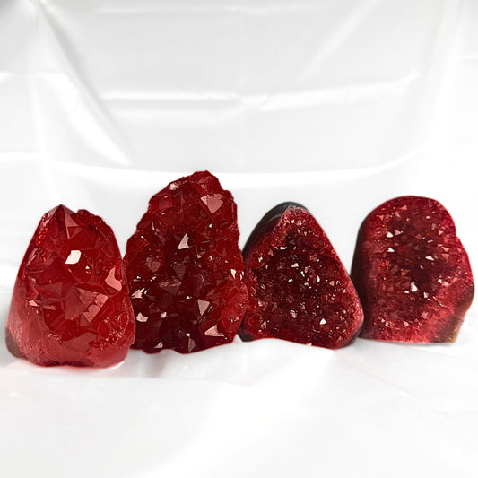 Four red amethyst crystal pieces in deep red shades. 