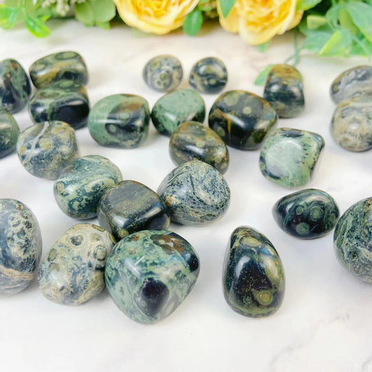 A set of Kabamba jasper tumbled stones with marbled swirls of sage green and beige on black.