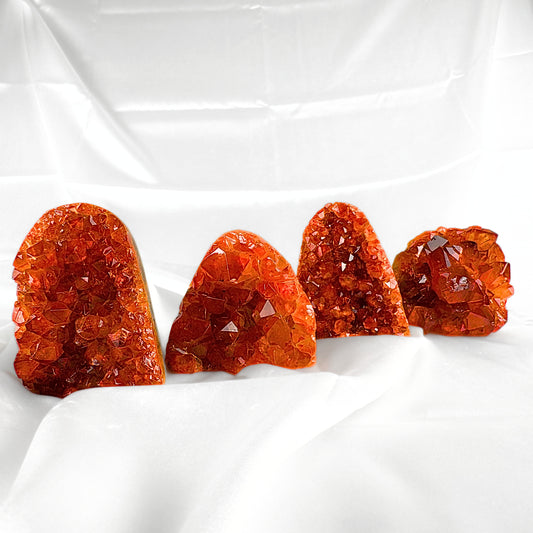 Four pieces of Orange Amethyst Crystal, in vibrant orange shades with distinct jagged sides.