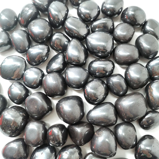 Hematite crystal tumbled stones in a metallic, steel grey that reflects the light.