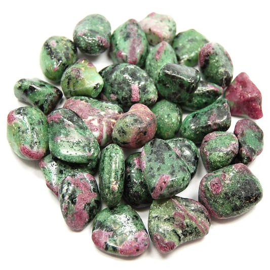 Several ruby zoisite crystal tumbled stones in a pile.